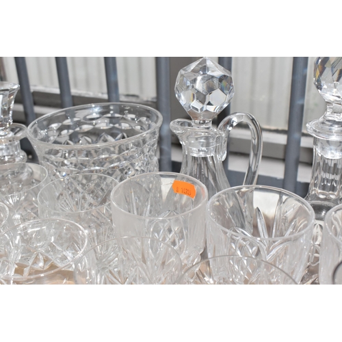 413 - A GROUP OF MOSTLY CLEAR CRYSTAL CUT GLASSWARE to include seven decanters of various form, a glass pu... 