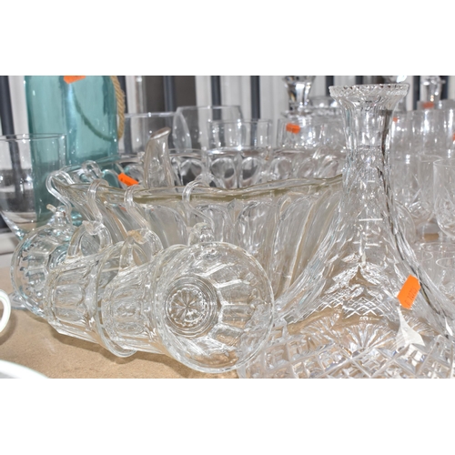 413 - A GROUP OF MOSTLY CLEAR CRYSTAL CUT GLASSWARE to include seven decanters of various form, a glass pu... 