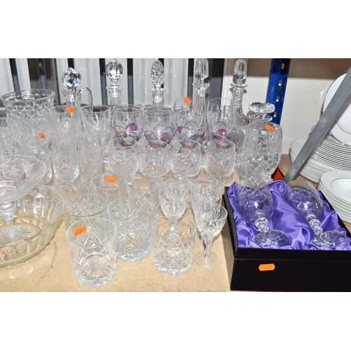 413 - A GROUP OF MOSTLY CLEAR CRYSTAL CUT GLASSWARE to include seven decanters of various form, a glass pu... 