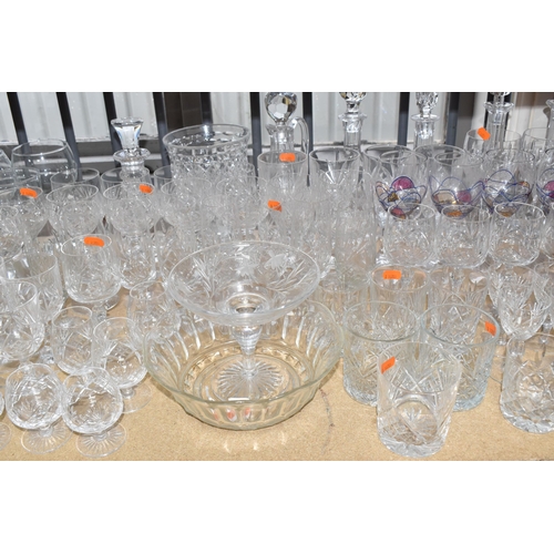 413 - A GROUP OF MOSTLY CLEAR CRYSTAL CUT GLASSWARE to include seven decanters of various form, a glass pu... 