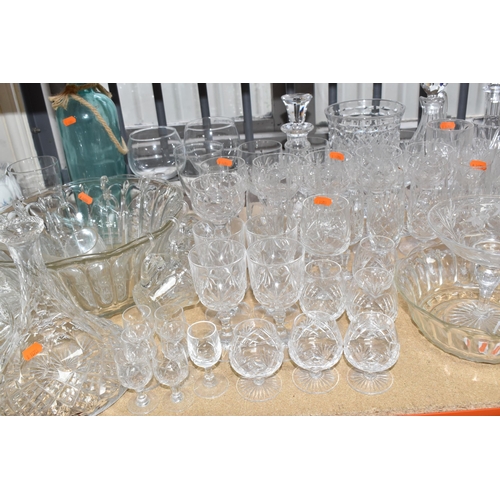 413 - A GROUP OF MOSTLY CLEAR CRYSTAL CUT GLASSWARE to include seven decanters of various form, a glass pu... 