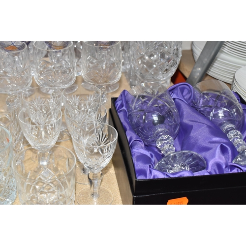 413 - A GROUP OF MOSTLY CLEAR CRYSTAL CUT GLASSWARE to include seven decanters of various form, a glass pu... 