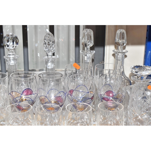 413 - A GROUP OF MOSTLY CLEAR CRYSTAL CUT GLASSWARE to include seven decanters of various form, a glass pu... 