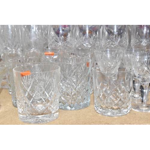 413 - A GROUP OF MOSTLY CLEAR CRYSTAL CUT GLASSWARE to include seven decanters of various form, a glass pu... 