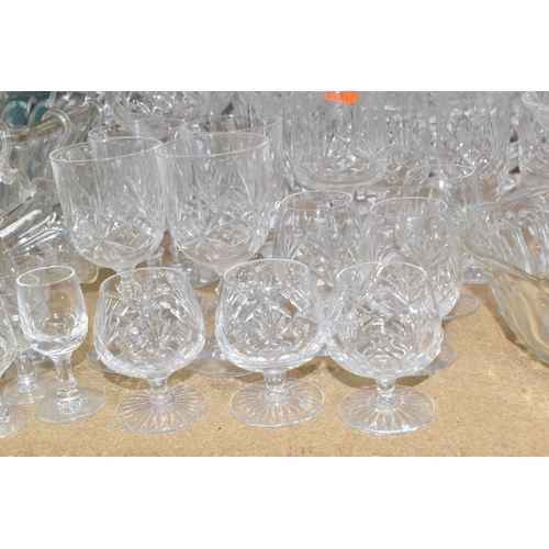 413 - A GROUP OF MOSTLY CLEAR CRYSTAL CUT GLASSWARE to include seven decanters of various form, a glass pu... 