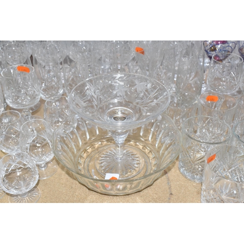 413 - A GROUP OF MOSTLY CLEAR CRYSTAL CUT GLASSWARE to include seven decanters of various form, a glass pu... 