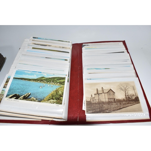 445 - TWO ALBUMS OF POSTCARDS to include one album comprising approximately two-hundred early twentieth ce... 