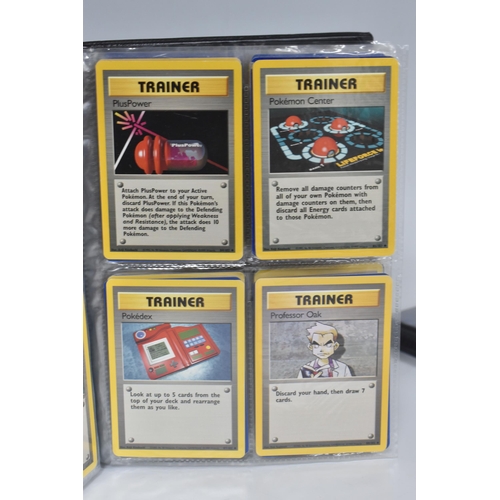 448 - TWO FOLDERS OF POKEMON CARDS, includes cards from the Base Set, Jungle, Fossil, Team Rocket and Prom... 