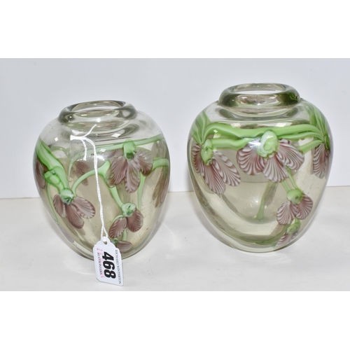 468 - A PAIR OF ART GLASS VASES, of ovoid form, decorated with pink and white orchid style flowers, on tra... 