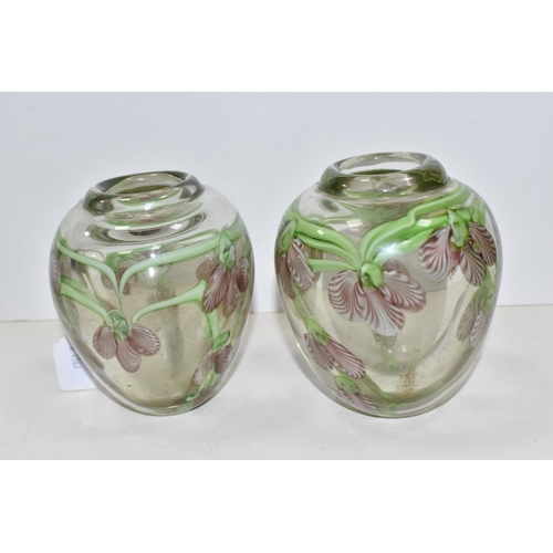 468 - A PAIR OF ART GLASS VASES, of ovoid form, decorated with pink and white orchid style flowers, on tra... 