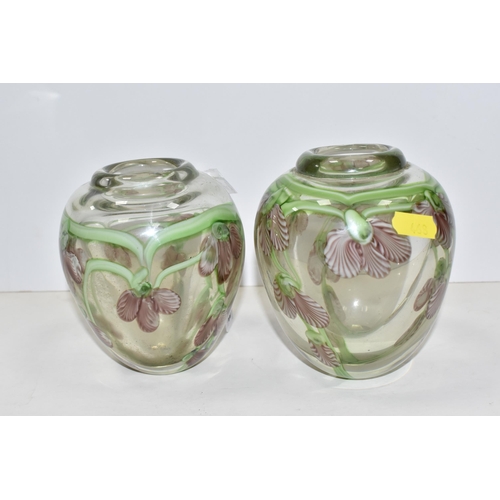 468 - A PAIR OF ART GLASS VASES, of ovoid form, decorated with pink and white orchid style flowers, on tra... 