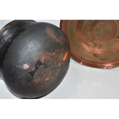 473 - A PERSIAN PAHLAVI PERIOD COPPER TRAY AND BLACK EARTHENWARE COOKING POT comprising an engraved Persia... 