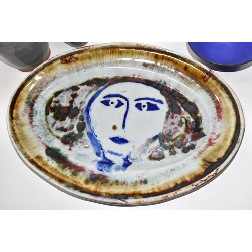 486 - FIVE VINTAGE POTTERY ITEMS, to include Lluis Castaldo large oval platter, with a women face painted ... 