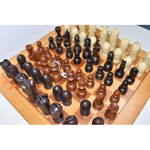 487 - A CHESSBOARD WITH TWO SETS OF CHESS PIECES, to include a Anne Carlton chess set, masked medieval fig... 