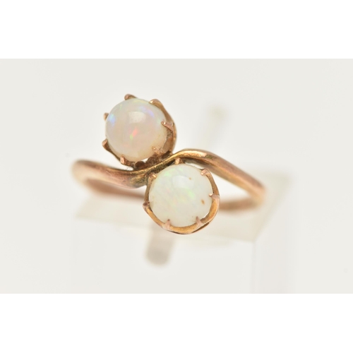 28 - AN EARLY 20TH CENTURY TOI ET MOI RING, two round cabochon opals prong set in yellow metal, stamped 9... 