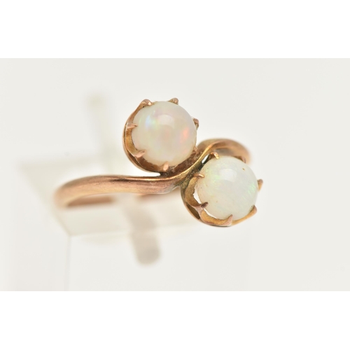 28 - AN EARLY 20TH CENTURY TOI ET MOI RING, two round cabochon opals prong set in yellow metal, stamped 9... 