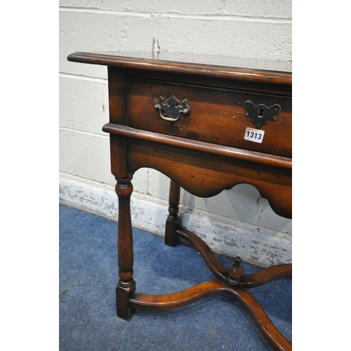 1313 - THEODORE ALEXANDER, A REPRODUCTION MAHOGANY SIDE TABLE / LOWBOY, with a single drawer, wavy apron, t... 