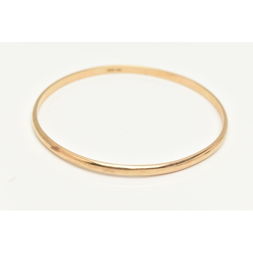 11 - A 9CT GOLD BANGLE, a yellow gold plain polished solid bangle, approximate internal diameter 71mm, ap... 