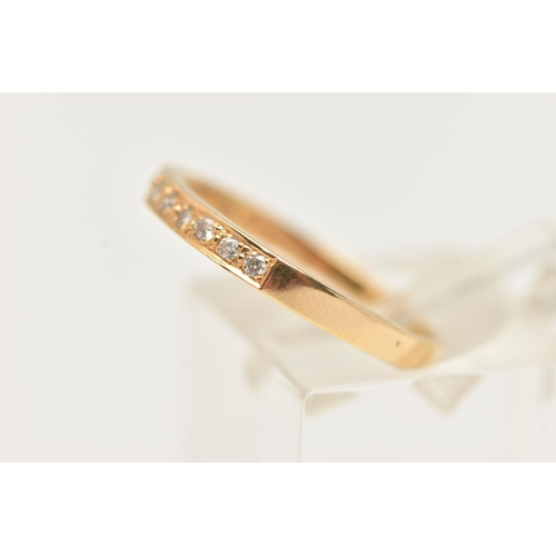 31 - A YELLOW METAL DIAMOND SET HALF ETERNITY RING, set with a row of nine small round brilliant cut diam... 