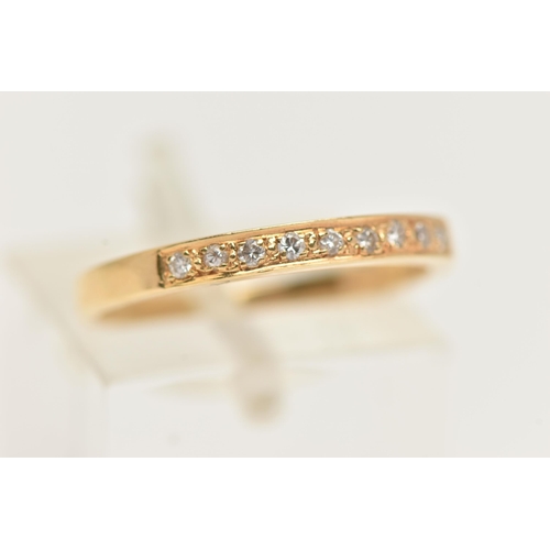 31 - A YELLOW METAL DIAMOND SET HALF ETERNITY RING, set with a row of nine small round brilliant cut diam... 