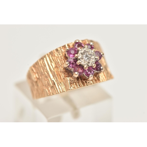 43 - A 9CT GOLD RUBY AND DIAMOND CLUSTER RING, set with a flower cluster of eight small circular cut rubi... 