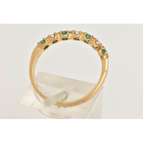 50 - AN 18CT GOLD EMERALD AND DIAMOND HALF ETERNITY RING, set with four small circular cut emeralds inter... 