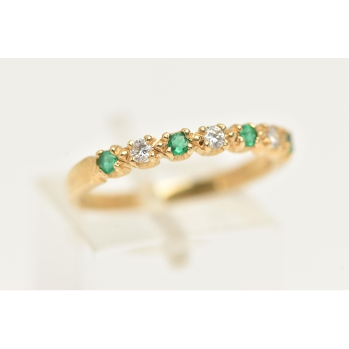 50 - AN 18CT GOLD EMERALD AND DIAMOND HALF ETERNITY RING, set with four small circular cut emeralds inter... 