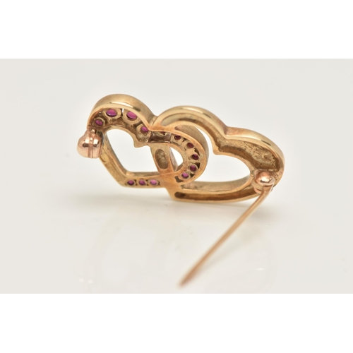 72 - A 9CT GOLD HEART BROOCH, two open work interlocking hearts one set with a row of square cut rubies, ... 