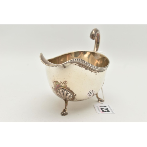 123 - A GEORGE V SILVER SAUCE BOAT, rope twist detail to the sauce boat rim, raised on three hoof feet, c ... 