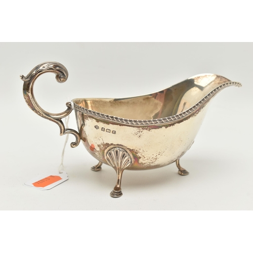 123 - A GEORGE V SILVER SAUCE BOAT, rope twist detail to the sauce boat rim, raised on three hoof feet, c ... 