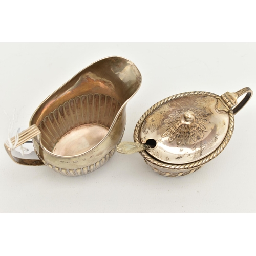 131 - TWO SILVER ITEMS, the first a small milk jug, rubbed Birmingham hallmark, the second a mustard, hall... 