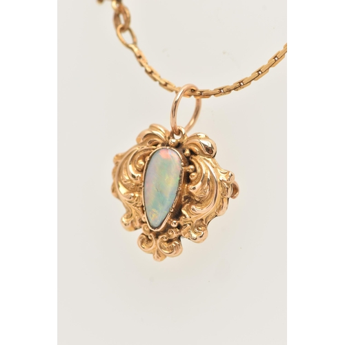 89 - A YELLOW METAL OPAL MOURNING PENDANT WITH AN ARTICULATED CHAIN, the pendant set with a white opal ca... 