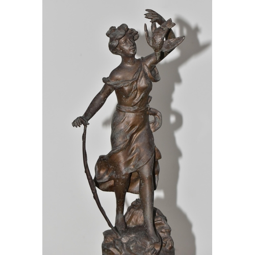 322 - A ROUGE MARBLE  MANTEL CLOCK,  a French clock surmounted by a spelter figure of a woman with a wild ... 