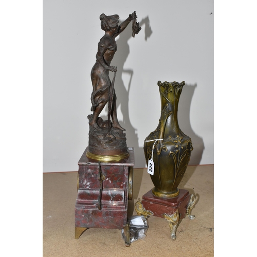 322 - A ROUGE MARBLE  MANTEL CLOCK,  a French clock surmounted by a spelter figure of a woman with a wild ... 