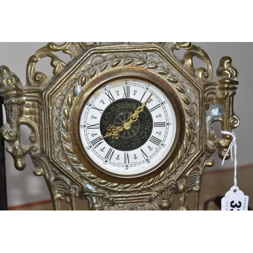 334 - A BLACK SLATE TIMEPIECE WITH A GOLD COLOURED CLOCK comprising a black slate mantel clock with three ... 