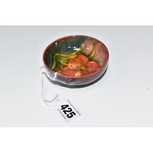 425 - A MOORCROFT POTTERY 'FREESIA' PATTERN FOOTED BOWL, diameter 8cm, a coral and yellow freesia on a mot... 