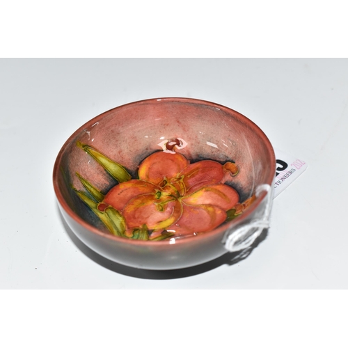 425 - A MOORCROFT POTTERY 'FREESIA' PATTERN FOOTED BOWL, diameter 8cm, a coral and yellow freesia on a mot... 