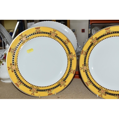 437 - VERSACE DINNER PLATES AND PLATED GRAVY BOAT, 'Barocco' design with yellow background rim black, yell... 