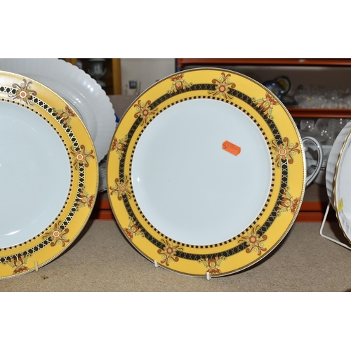 437 - VERSACE DINNER PLATES AND PLATED GRAVY BOAT, 'Barocco' design with yellow background rim black, yell... 