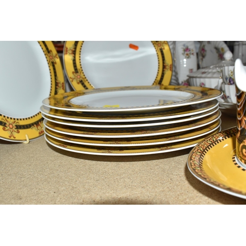 437 - VERSACE DINNER PLATES AND PLATED GRAVY BOAT, 'Barocco' design with yellow background rim black, yell... 