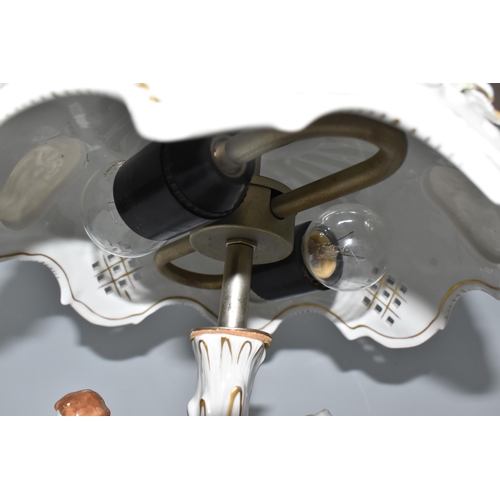 446 - AN EAST-GERMAN TWENTIETH CENTURY PORCELAIN FIGURAL LAMP with a pierced rococo style shade with litho... 