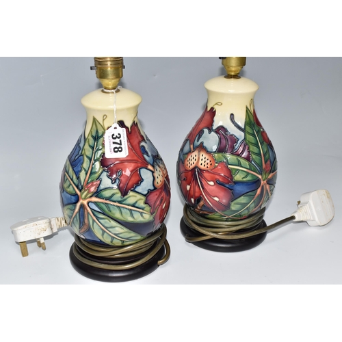 378 - A PAIR OF MOORCROFT BALUSTER LAMP BASES designed by Philip Gibson for Moorcroft Pottery with a tube-... 