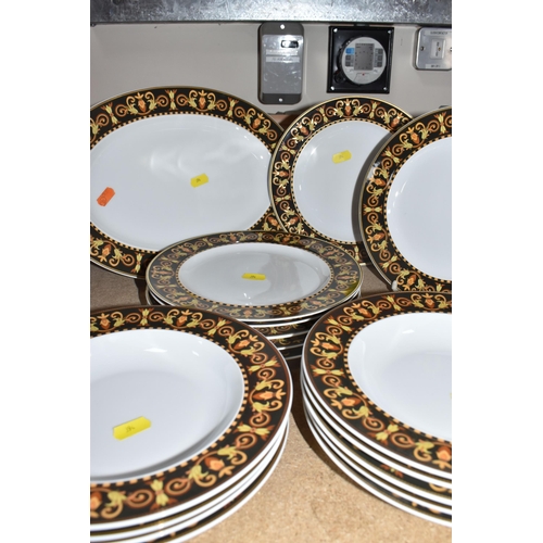 394 - A COLLECTION OF VERSACE DINNERWARE 'BAROCCO', a design of a black back ground rim, with shades of ye... 