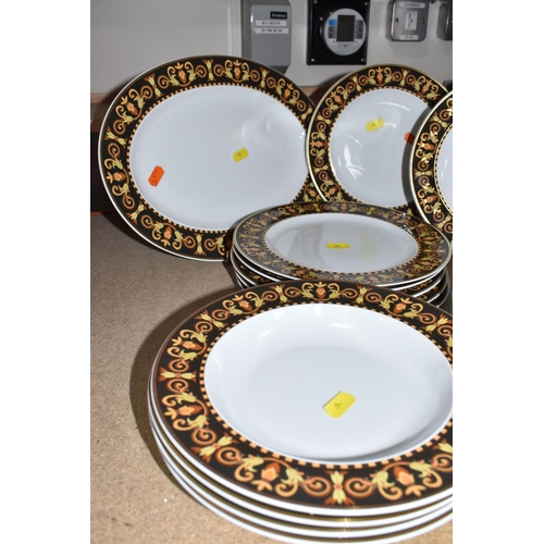 394 - A COLLECTION OF VERSACE DINNERWARE 'BAROCCO', a design of a black back ground rim, with shades of ye... 