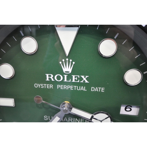 1202 - A ROLEX OYSTER PERPETUAL DATE SUBMARINER DEALERS ADVERTISING WALL CLOCK, with a green dial, diameter... 