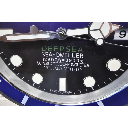 1203 - A ROLEX OYSTER PERPETUAL DATE DEEP SEA SEA-DWELLER DEALERS ADVERTISING WALL CLOCK, with a blue dial,... 