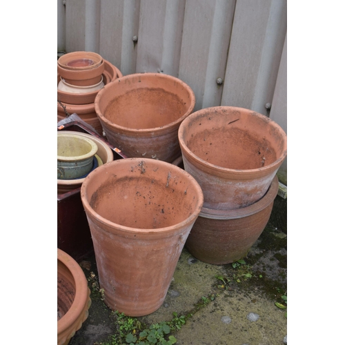 1002 - A LARGE SELECTION OF GLAZED AND TERRACOTTA PLANT POTS, of various sizes and shapes, along with a pai... 