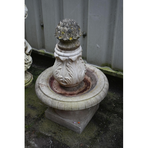 1012 - A WEATHERED COMPOSITE SHELL SHAPED BIRD BATH, on a later base depicting a standing otter, height 64c... 