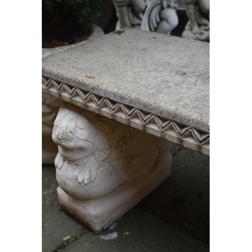 1013 - A WEATHERED PAINTED COMPOSITE GARDEN BENCH, on a pair of stands depicting lions on a ball, length 12... 