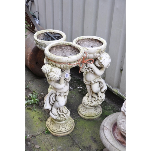 1015 - THREE COMPOSITE PLANTERS, of three cherubs that are each holding a bowl aloft, diameter 38cm x heigh... 